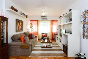 a living room with a couch and a tv at Copacabana Beach Amazing Lux 2 Bedroom Apartment in Rio de Janeiro