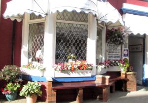 
a patio table with flowers on top of it at Bamford House Hotel in Blackpool
