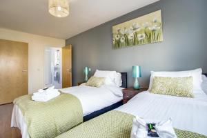 a hotel room with two beds and two lamps at Mica Point City Centre Apartment in Birmingham