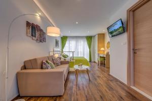 a living room with a couch and a table at Room&studio Apartment Just Enjoy in Split