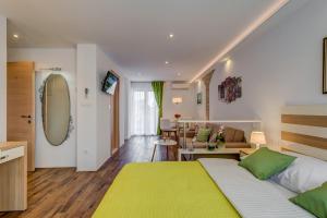 a bedroom with a large bed and a living room at Room&studio Apartment Just Enjoy in Split