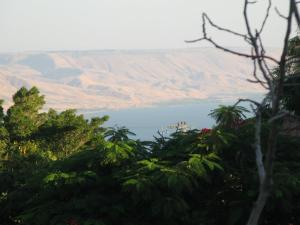 a view of a body of water with mountains in the background at Lovely home above the Kinneret in Karkom