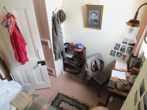 a room with a bedroom with a door and a desk at Dylan Thomas House in Swansea