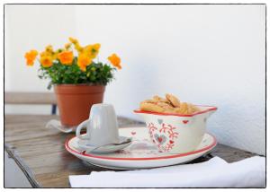 a bowl of peanuts sitting on a table with a plate at Santo Stefano in Putignano