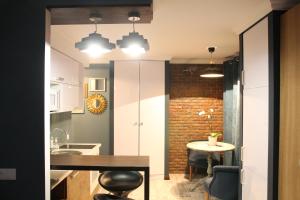 a kitchen with a table and a dining room at LUXE on Tereshkovoy 8 in Novosibirsk