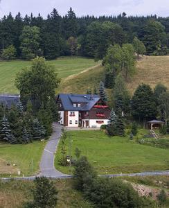 a house on a hill with a road leading to it at Ferienwohnungen Altenberg ERZ 060 in Am Donnerberg