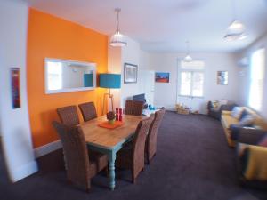 a dining room with a table and chairs at Windsor Cottage in Kingston Beach