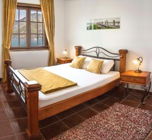 a bedroom with a bed with white sheets and pillows at Apartments Boka Vista in Kamenari