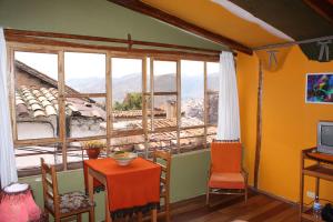 a room with a table and chairs and a window at Casa De Mama Cusco - The Treehouse in Cusco