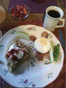 a plate of food with an egg on a table at Fairview Manor Bed and Breakfast in Ben Lomond