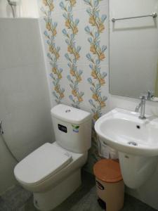 a bathroom with a toilet and a sink at Ouidee Resort in Na Noi