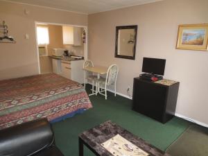 a hotel room with two beds and a kitchen at Overlander Motel in Chase