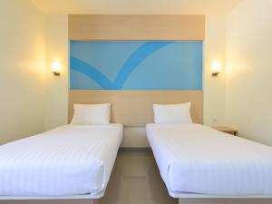 Postel nebo postele na pokoji v ubytování HOP INN Rayong