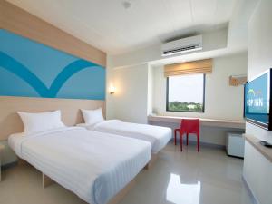 Postel nebo postele na pokoji v ubytování HOP INN Rayong