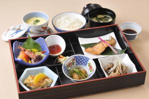a tray filled with different types of food on a table at Hotel Crown Hills Kushiro in Kushiro