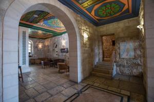 a hallway with a building with a colorful ceiling at Abrahams Herberge - Beit Ibrahem in Bethlehem