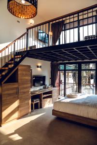 a bedroom with a loft bed and a staircase at 15 Palms Beach Resort in Ko Chang