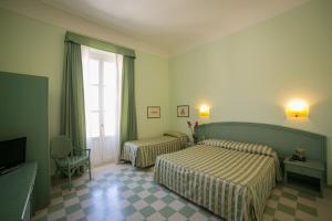 Кровать или кровати в номере Gran Bretagna Boutique Hotel Ortigia