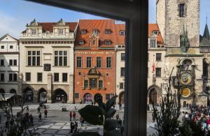a view of a city square from a window at Grand Hotel Praha in Prague