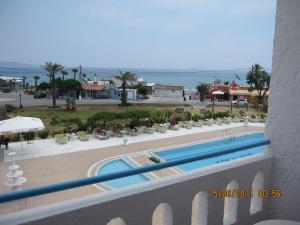 a view of a swimming pool and the ocean at Kokalakis Hotel in Kefalos