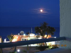 a view of a building at night with a moon at Kokalakis Hotel in Kefalos