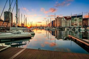 a group of boats docked in a marina at sunset at O-Mer Oostende in Ostend