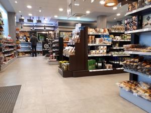 a store aisle of a grocery store with a person walking through it at Hotel Beasain in Beasain