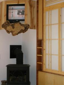 a room with a fireplace and a tv on a wall at Secret Garden Inn in San Diego