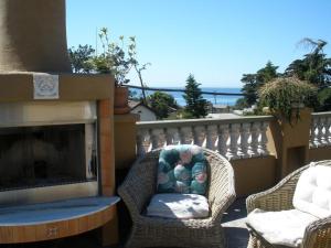 a wicker chair sitting next to a fireplace at Secret Garden Inn in San Diego