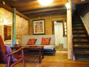 a living room with a couch and a table and stairs at Qi Tang lane in Jiufen