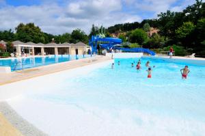 a group of people in the water at a swimming pool at Domaine du Surgié in Figeac