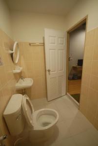 a bathroom with a white toilet and a sink at Inn Stations Hostel in Bangkok
