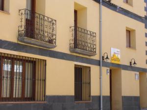 a building with barred windows on the side of it at Hostal Castilla in Serón de Nájima