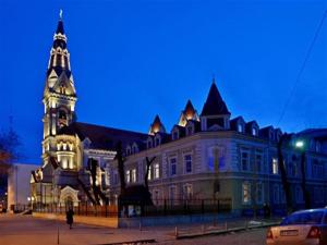 a large building with a clock tower at night at Saint Paul Odessa in Odesa