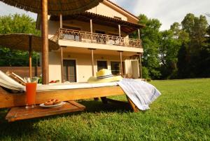 a bed in front of a house in the grass at Jasmin Apartments in Skiathos