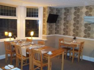 a dining room with wooden tables and chairs at The Almar in Scarborough