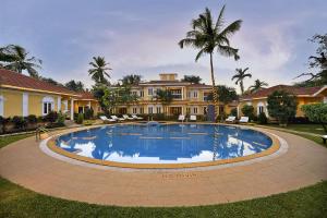 a large swimming pool in front of a house at Casa De Goa - Boutique Resort - Calangute in Calangute