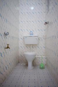 納庫魯的住宿－Fairfield Resort，浴室设有卫生间,墙壁以蓝色和白色瓷砖装饰。