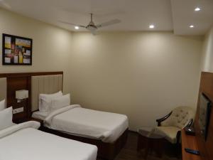 Ένα ή περισσότερα κρεβάτια σε δωμάτιο στο Hotel Tridev