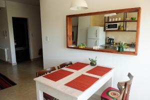 a dining room table with a mirror on the wall at Departamento Salta in Salta