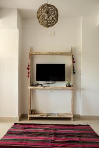 ein Wohnzimmer mit einem Flachbildfernseher an der Wand in der Unterkunft Punto Norte Departamentos con encanto en Salta - Aniceto in Salta