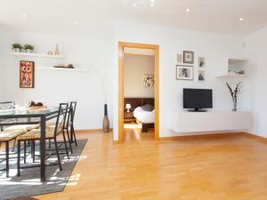 a living room with a dining table and a television at RentBCN Rambla Catalunya Apartment in Barcelona