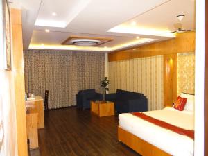 Ένα ή περισσότερα κρεβάτια σε δωμάτιο στο Hotel Tridev