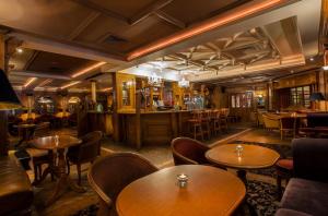 a restaurant with tables and chairs and a bar at Ardboyne Hotel in Navan
