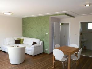a living room with a white couch and a table at Twee Linden Warnemünde Stolteraa in Warnemünde