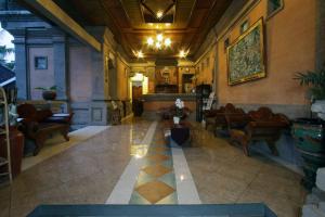 a lobby with couches and chairs in a building at Nick's Hidden Cottages by Mahaputra-CHSE Certified in Ubud