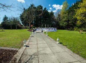 a walkway in a park with a bench in the grass at Ardboyne Hotel in Navan