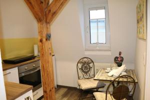 a kitchen with a table and chairs and a window at Fewo Friedrichsruh in Bad Elster