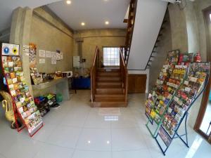 a room with a staircase and a book store at The Ghee House in Chiang Mai
