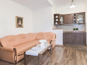 a living room with a couch and a table at VacationClub - Trzy Korony Wazow Apartment 12 in Świnoujście